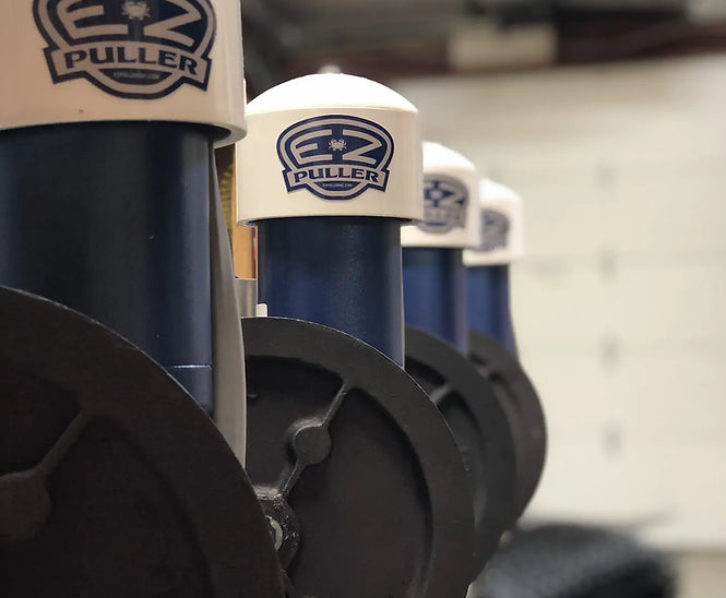 A line of EZ Puller blue motors with EZ Puller logo on the white caps